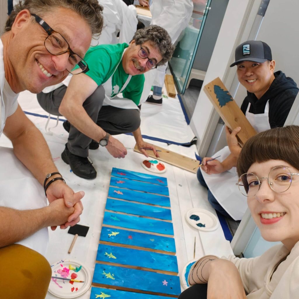 Team painting bench with colorful designs