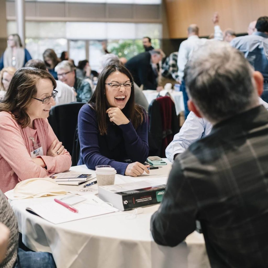 corporate retreat_06_hands_up_full_room