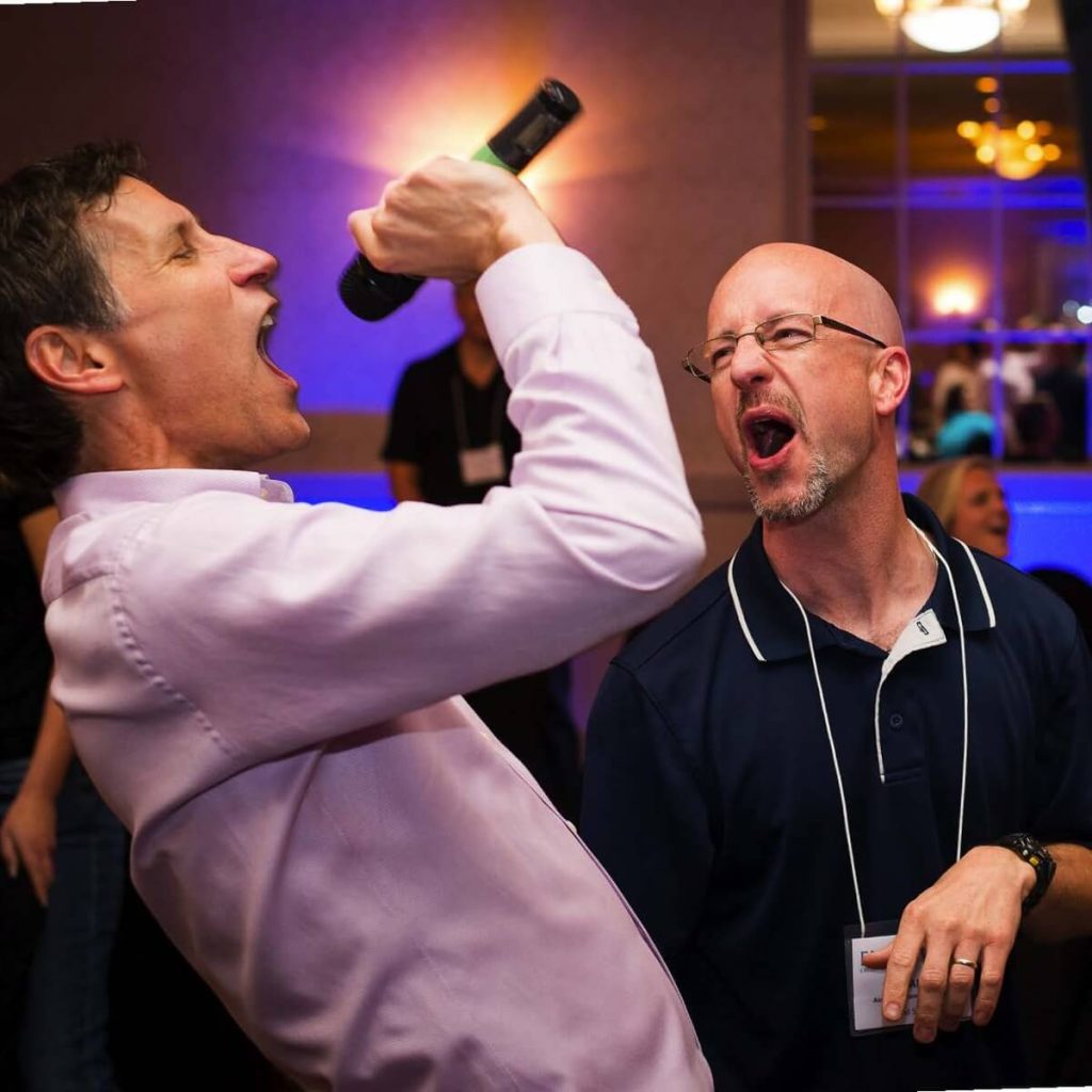 Game show host with microphone + crowd